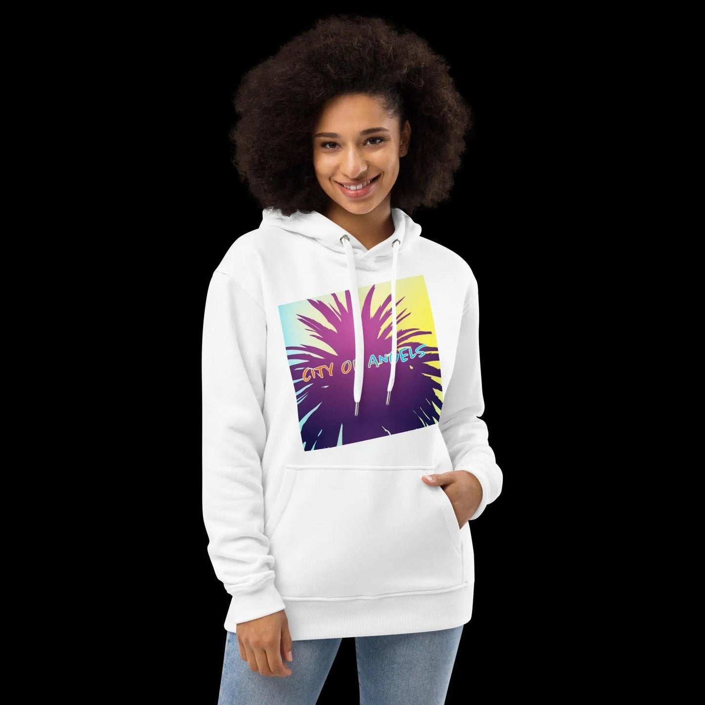 Woman wearing white SPECIAL EDITION CITY OF ANGELS Premium eco hoodie with colorful palm tree graphic and front pouch pocket