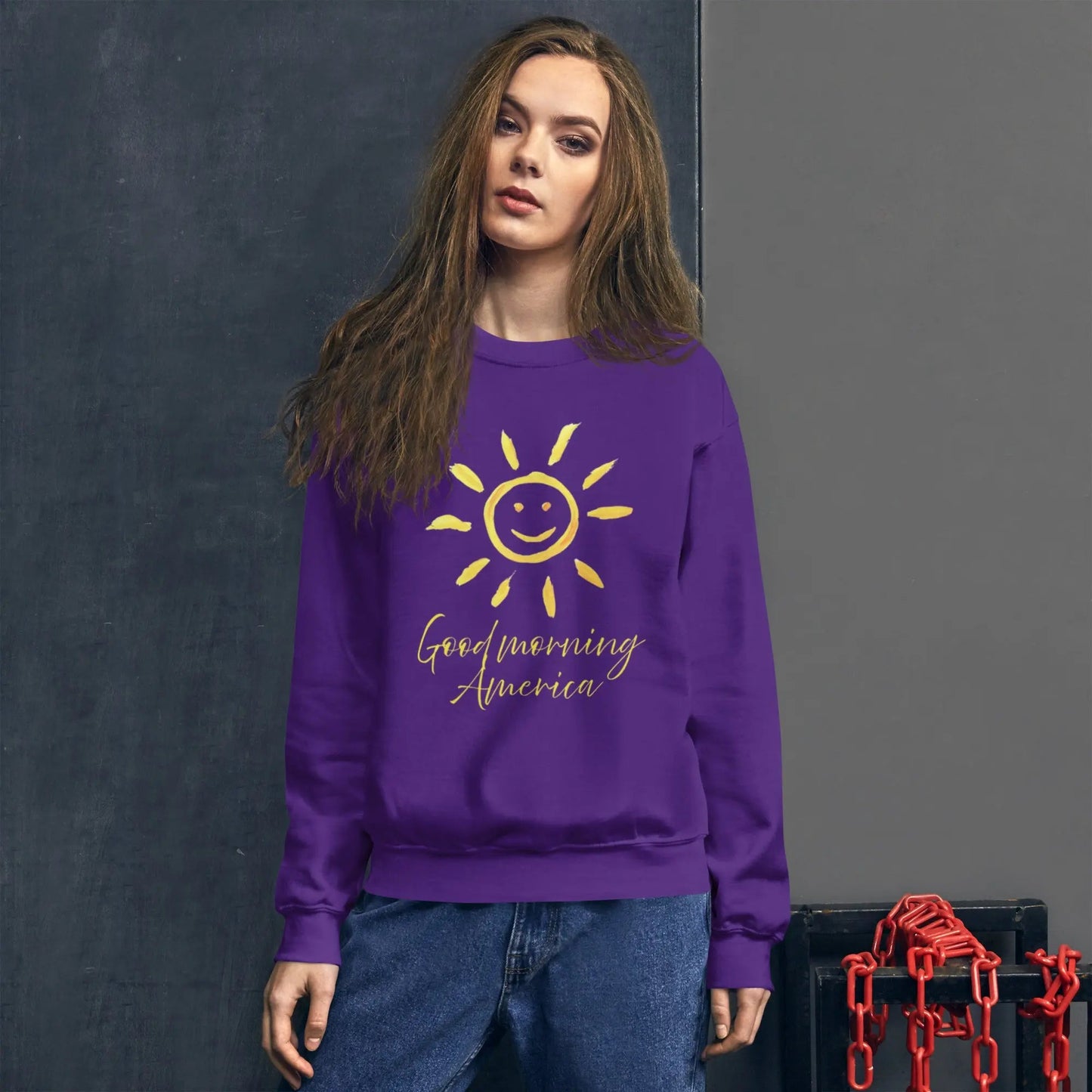 Purple HAPPY MOOD Unisex Sweatshirt with yellow sun graphic and "Good morning America" text worn by woman