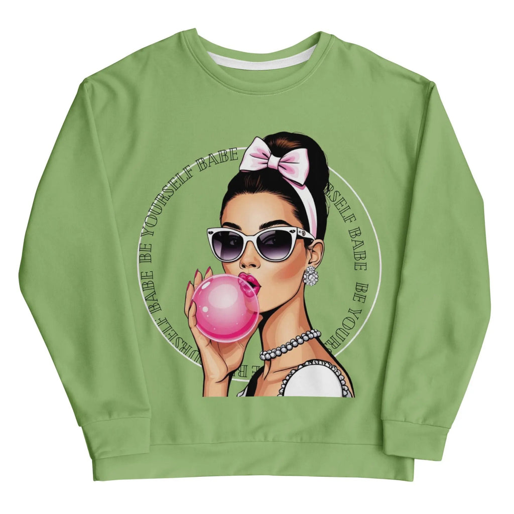 Unisex sweatshirt with green fabric featuring a retro-style woman blowing bubblegum and wearing sunglasses with the text "Be Yourself Babe" in a circle design.