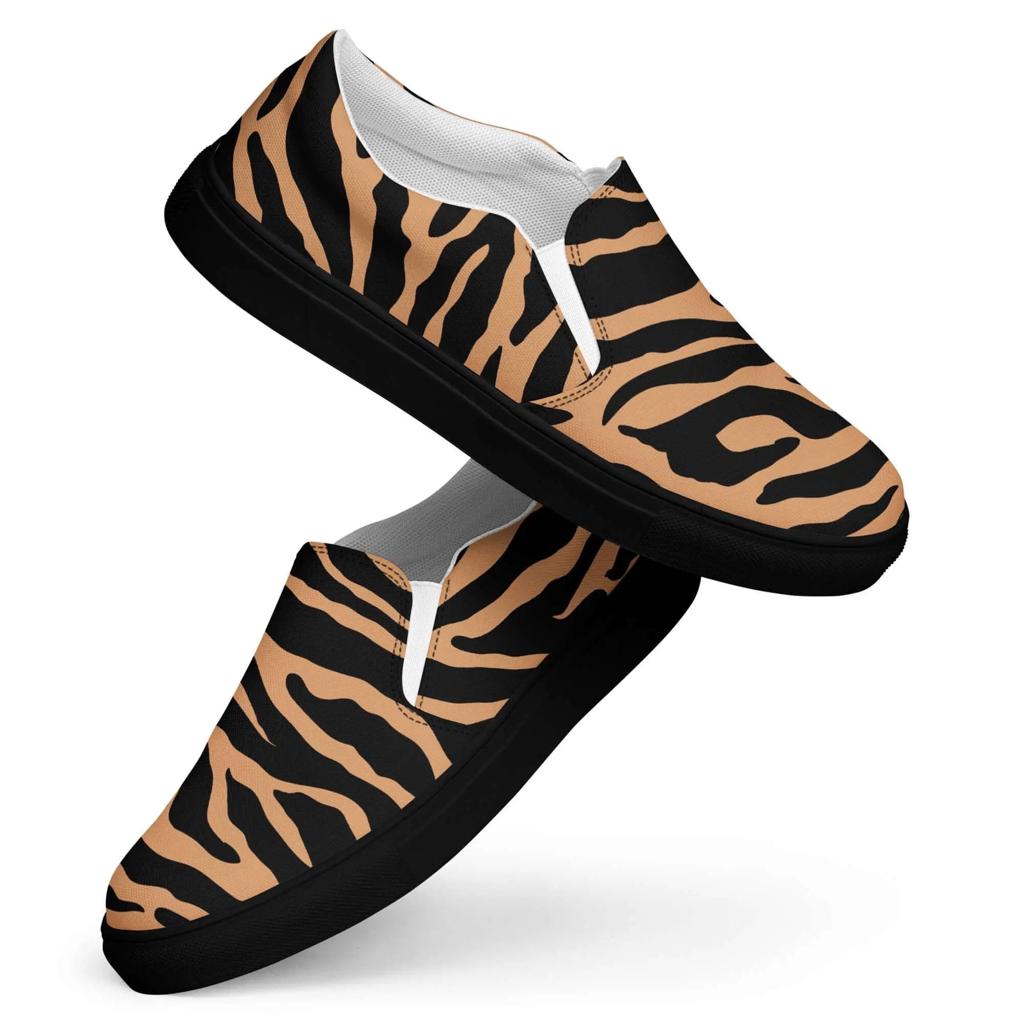 Women's slip-on canvas shoes with black and tan tiger stripe pattern and black rubber soles